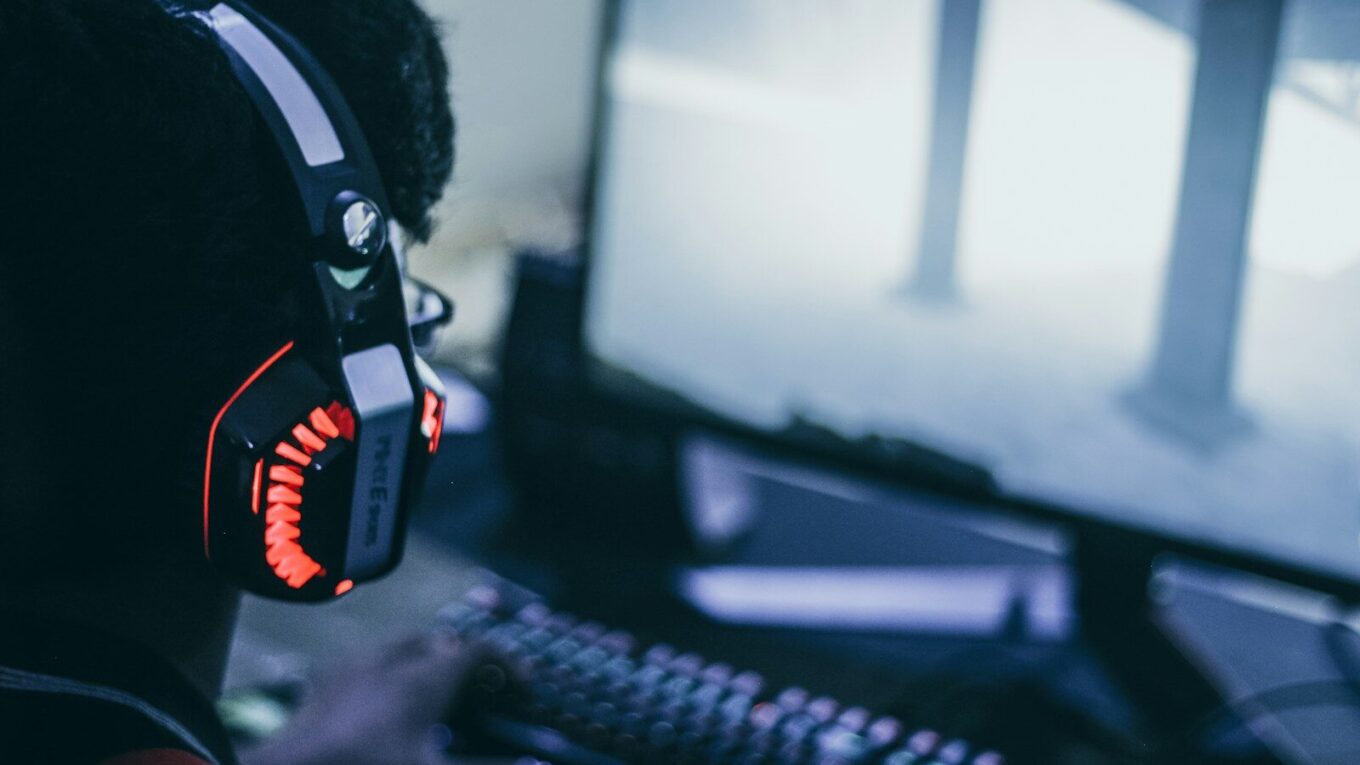 person wearing orange and black headphones